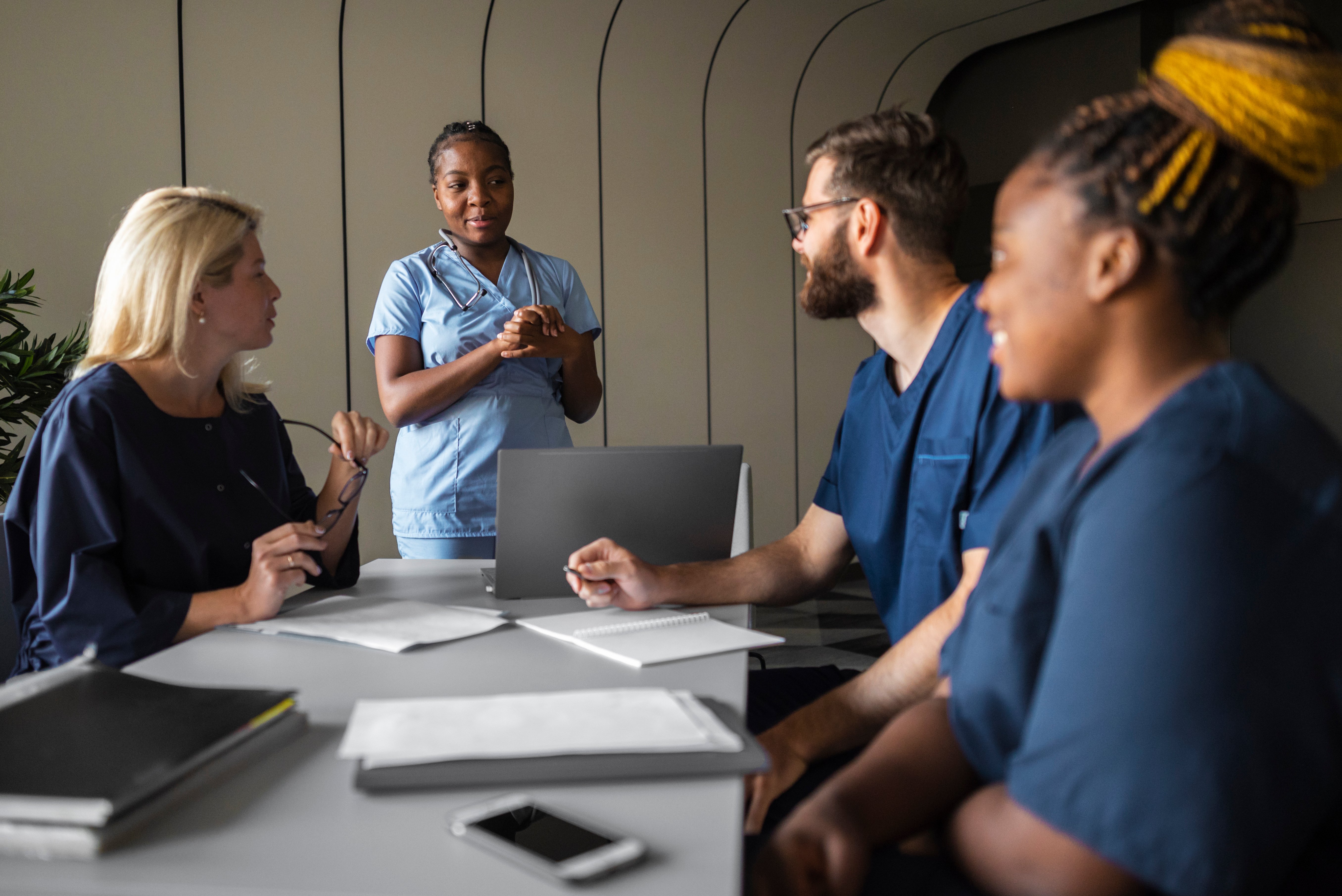Group of diverse healthcare professionals in a team meeting, symbolising collaboration, growth, and high-demand careers in 2025