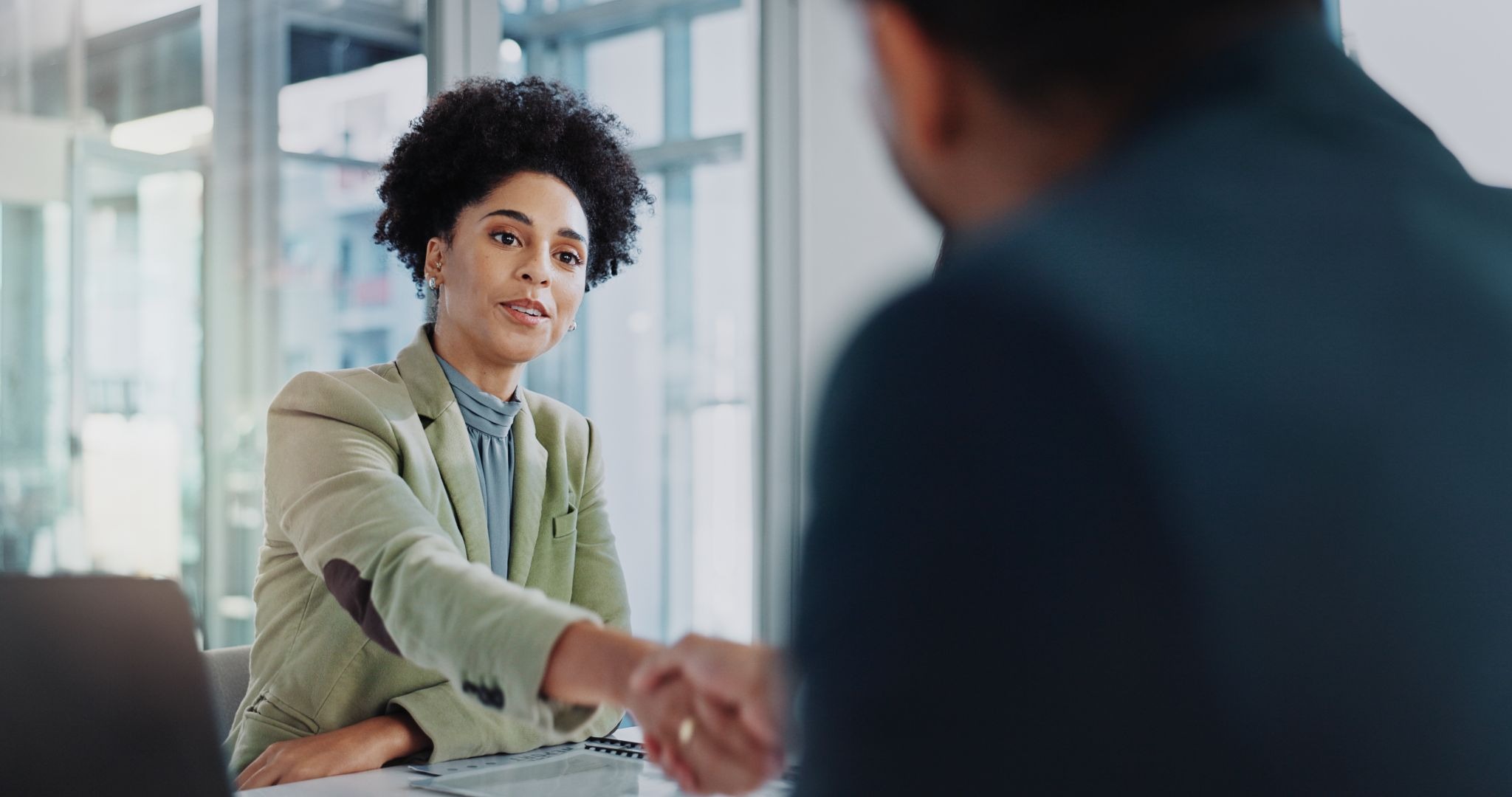 Professional woman accepting a job offer after returning to the workforce.