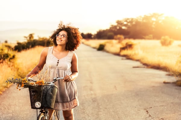 Woman with bike on countryside road