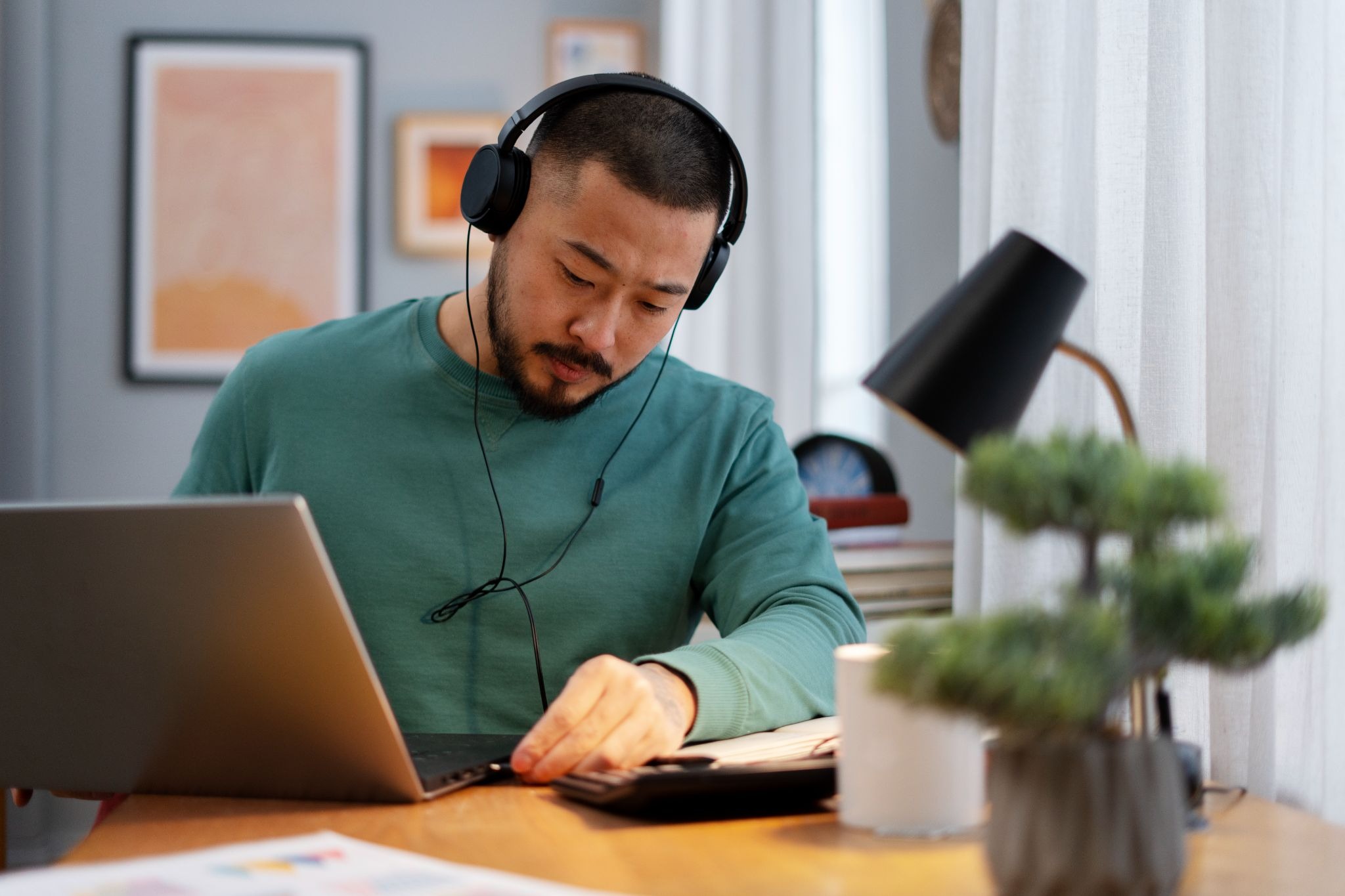 A focused person completing online studies on a laptop, illustrating upskilling for career advancement
