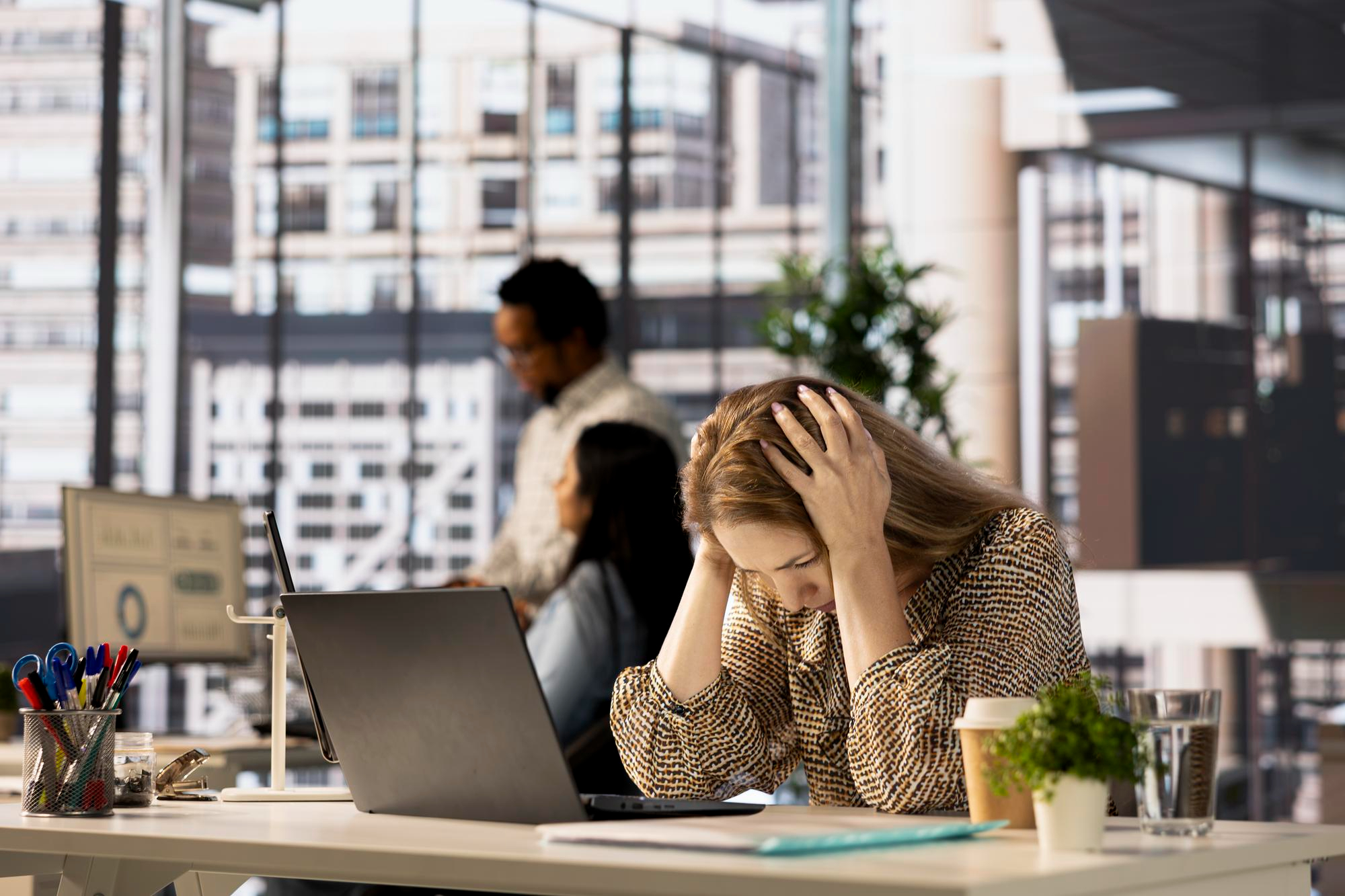 Stressed woman at her desk realising her burnout is pushing her toward new career change ideas